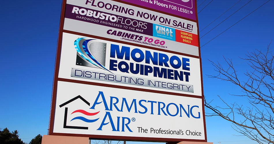 Outdoor retail signs for Monroe Equipment in Wisconsin.